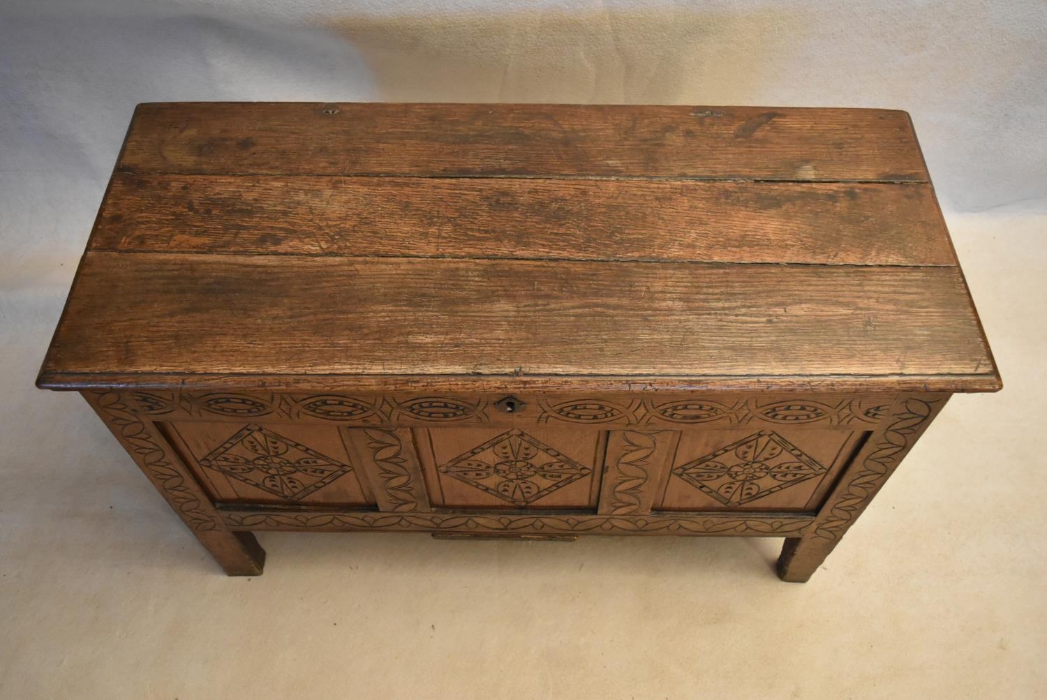 An 18th century country oak coffer with its original hinges and lozenge carved panels raised on - Image 3 of 10