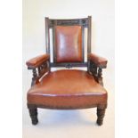 A late Victorian carved mahogany armchair in faux leather upholstery. H.104 W.68 D.68cm