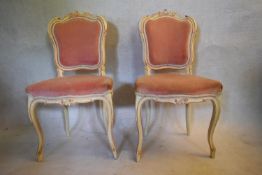 A pair of early 20th century Rococo carved and painted salon chairs on cabriole supports. H.87 W.