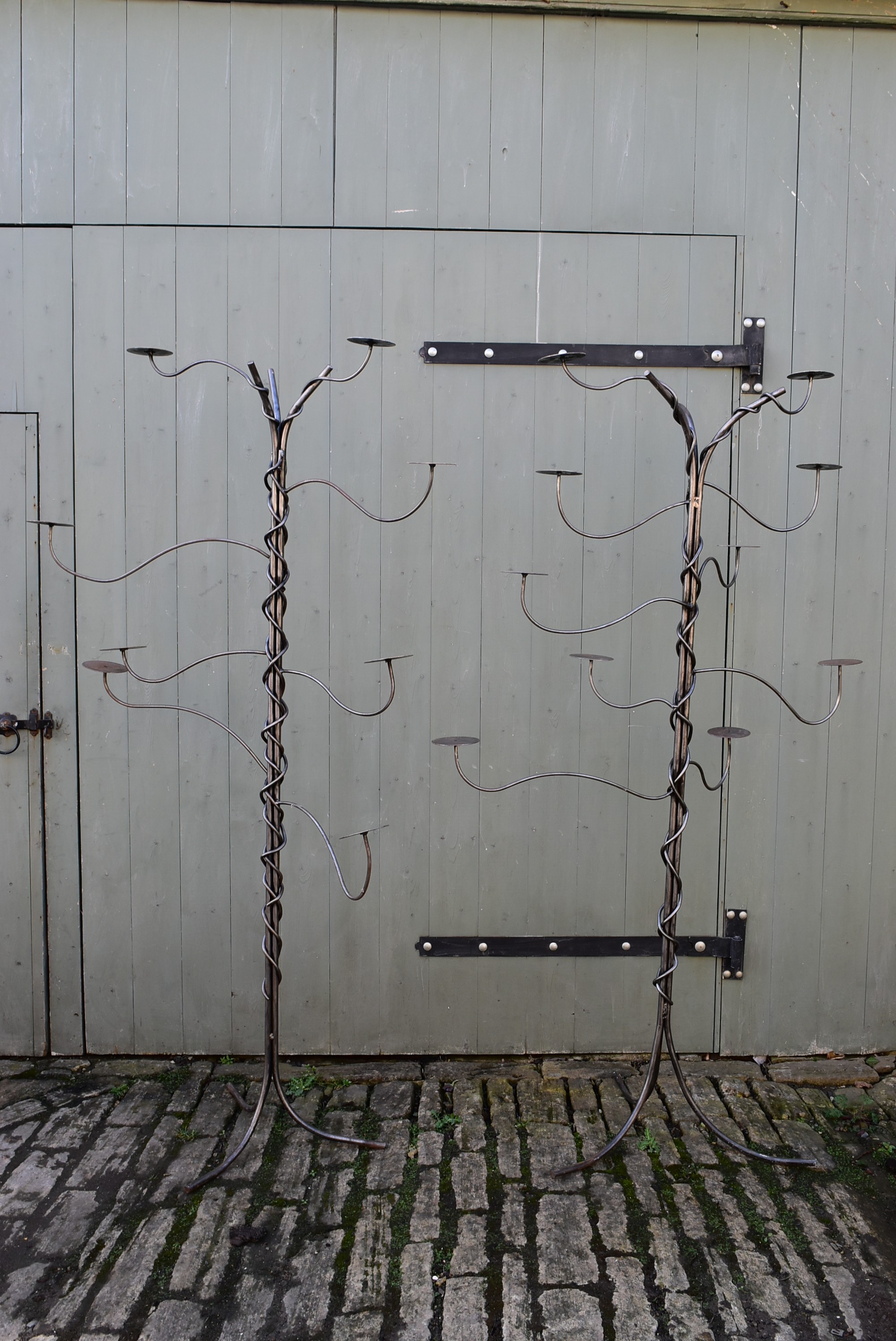 WITHDRAWN - A pair of bespoke tall steel coat hangers or candle stands. H.190 W.85cm