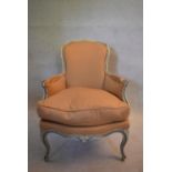 A Louis XV style fauteuil with painted frame and piped terracotta upholstery on cabriole supports.