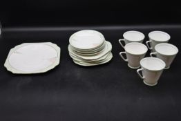 An Art Deco porcelain six person tea set with cups, saucers and side plates, one cup missing. H.21cm