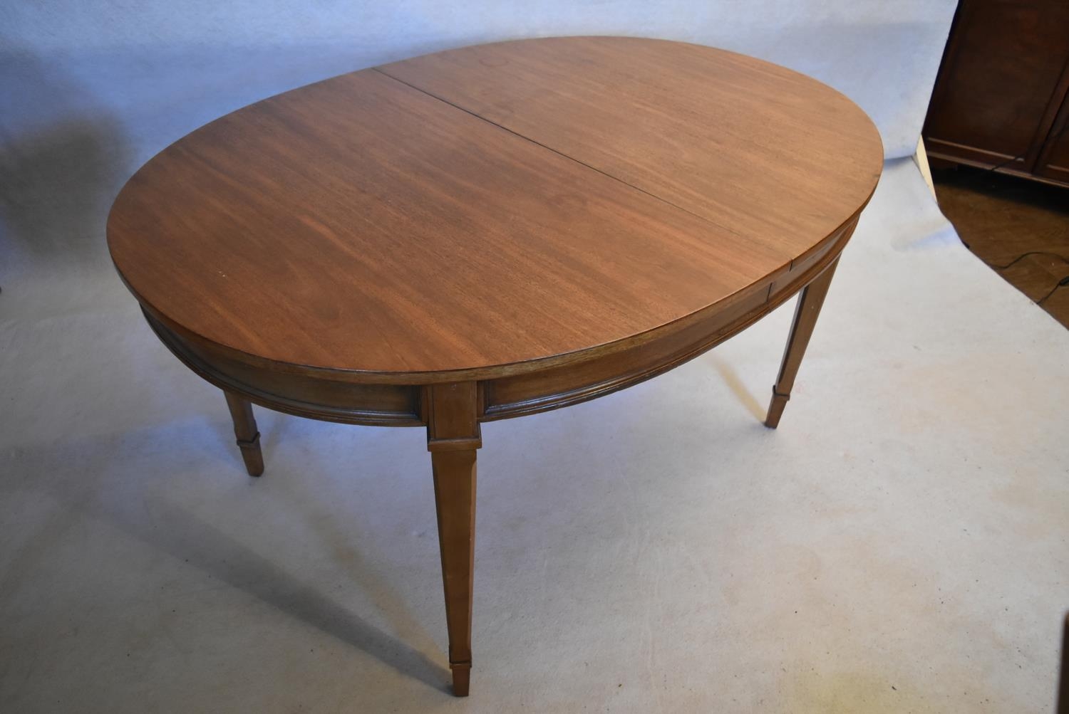 A walnut extending dining table with three extra leaves raised on square tapering supports. H.73 W. - Image 5 of 11