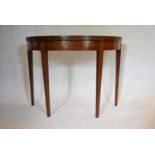 A Georgian mahogany demi lune tea table with fold over top on square tapering gateleg supports. H.73