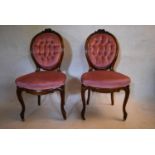 A pair of 19th century mahogany salon chairs with floral carved backs in deep studded velour