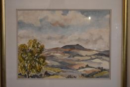 A framed and glazed watercolour of a hilly country landscape. Signed Wilfred Wilson. H.54 W.64cm