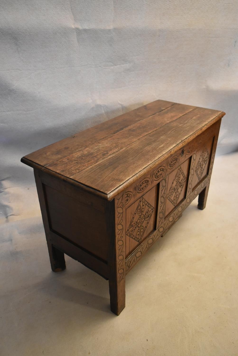 An 18th century country oak coffer with its original hinges and lozenge carved panels raised on - Image 5 of 10