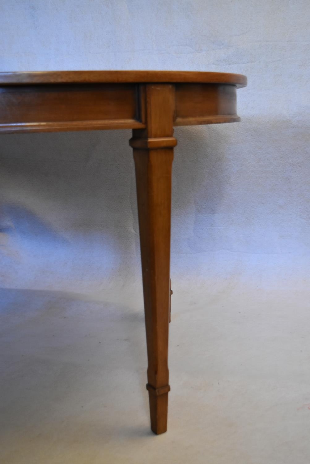 A walnut extending dining table with three extra leaves raised on square tapering supports. H.73 W. - Image 6 of 11