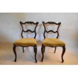 A pair of 19th century rosewood shaped back dining chairs on cabriole supports. H.79 W.45 D.42cm