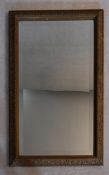 A 19th century bevelled plate wall mirror in giltwood and gesso frame. H.96 W.62cm