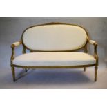 A 19th century French carved giltwood canape with ribbon and floral carved back rail reupholstered