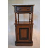 A late 19th century walnut and ebonised pot cupboard with marble top above frieze drawer and fielded