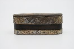 A engraved white metal and leather tin lined snuff box. An engraved shield shape cartouche and