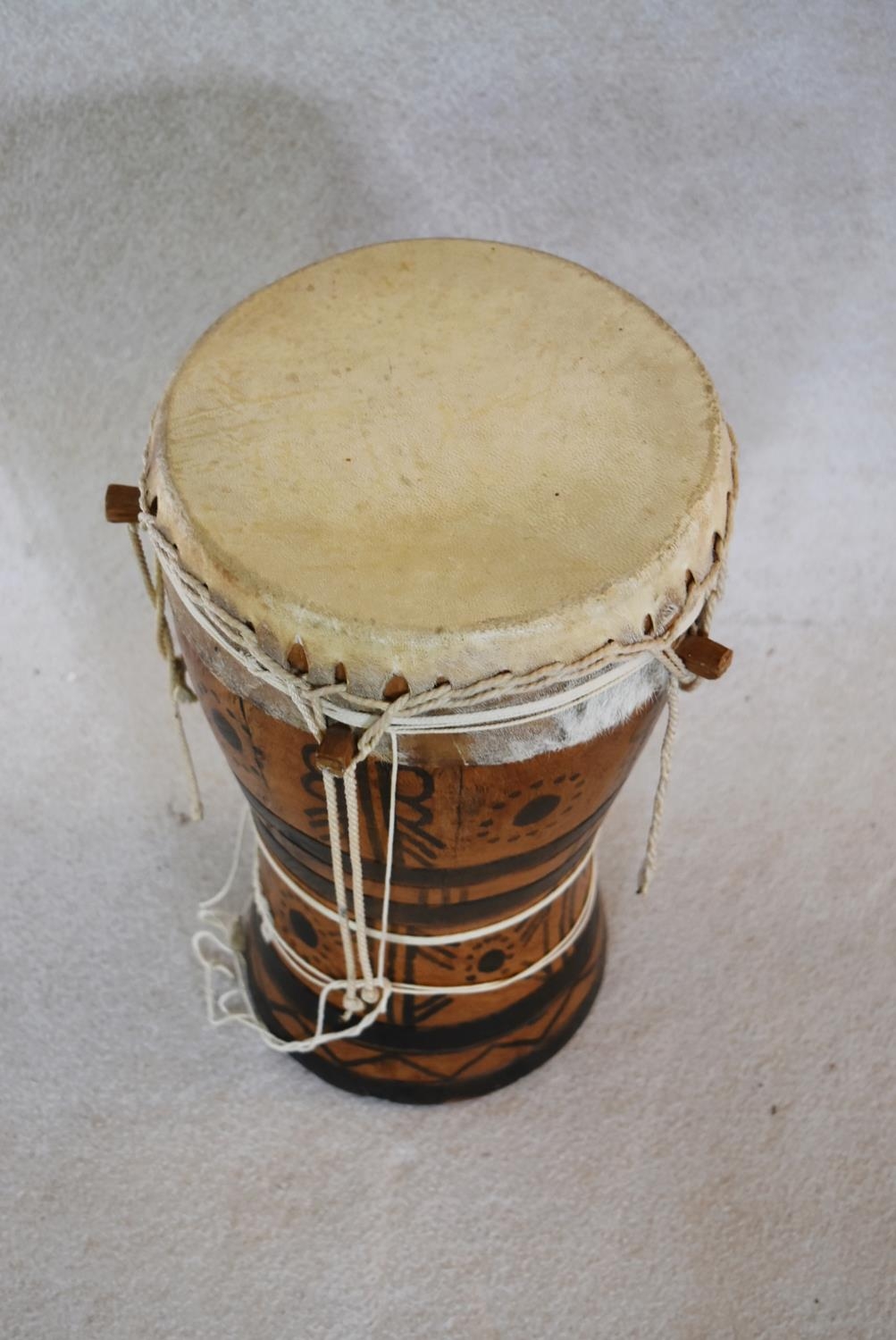 A Senegalese painted hardwood tribal drum. H.44 W.25cm - Image 2 of 6