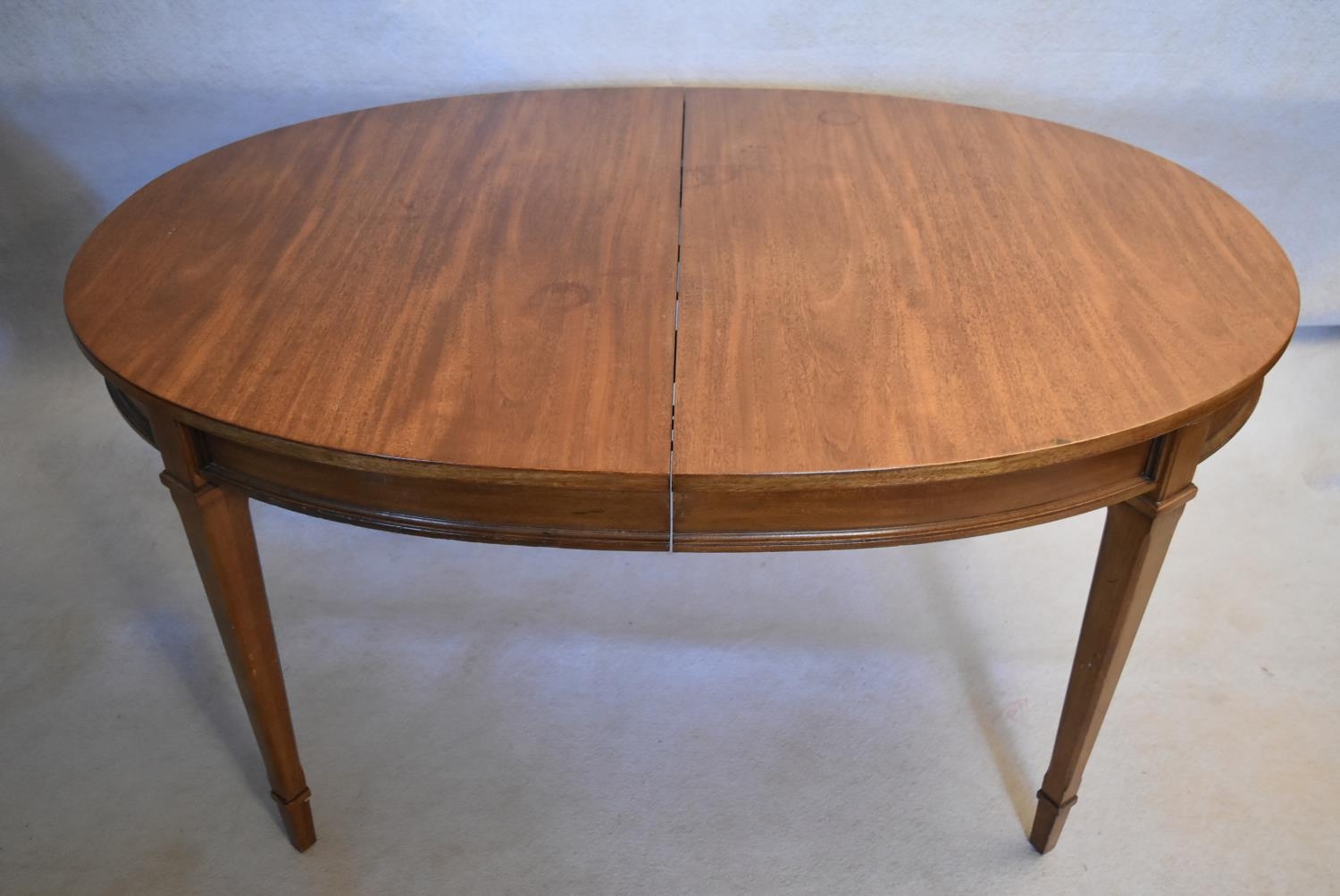 A walnut extending dining table with three extra leaves raised on square tapering supports. H.73 W. - Image 2 of 11