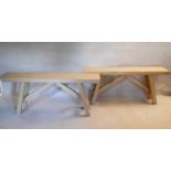 A pair of 20th century limed oak console tables or high benches, heavy planked tops on trestle style