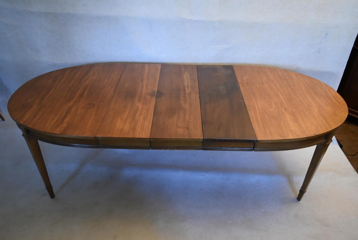 A walnut extending dining table with three extra leaves raised on square tapering supports. H.73 W. - Image 8 of 11