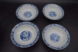 Four Qing dynasty blue and white footed shallow porcelain bowls. Decorated with figures and temple