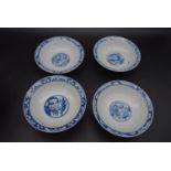 Four Qing dynasty blue and white footed shallow porcelain bowls. Decorated with figures and temple