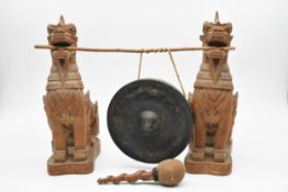 A Chinese gilded bronze dinner gong with carved dragons holding the support bar in their mouths. H.