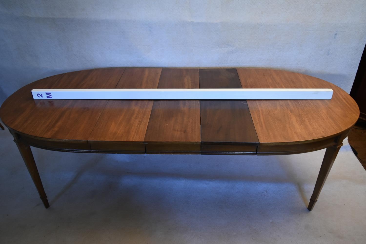 A walnut extending dining table with three extra leaves raised on square tapering supports. H.73 W. - Image 11 of 11