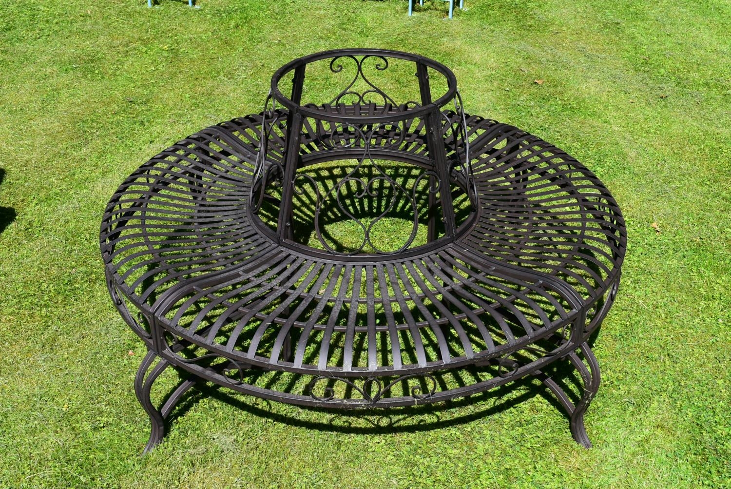 A wrought metal four section tree trunk bench with scroll decorated back and slatted seat. H.75 - Image 3 of 5