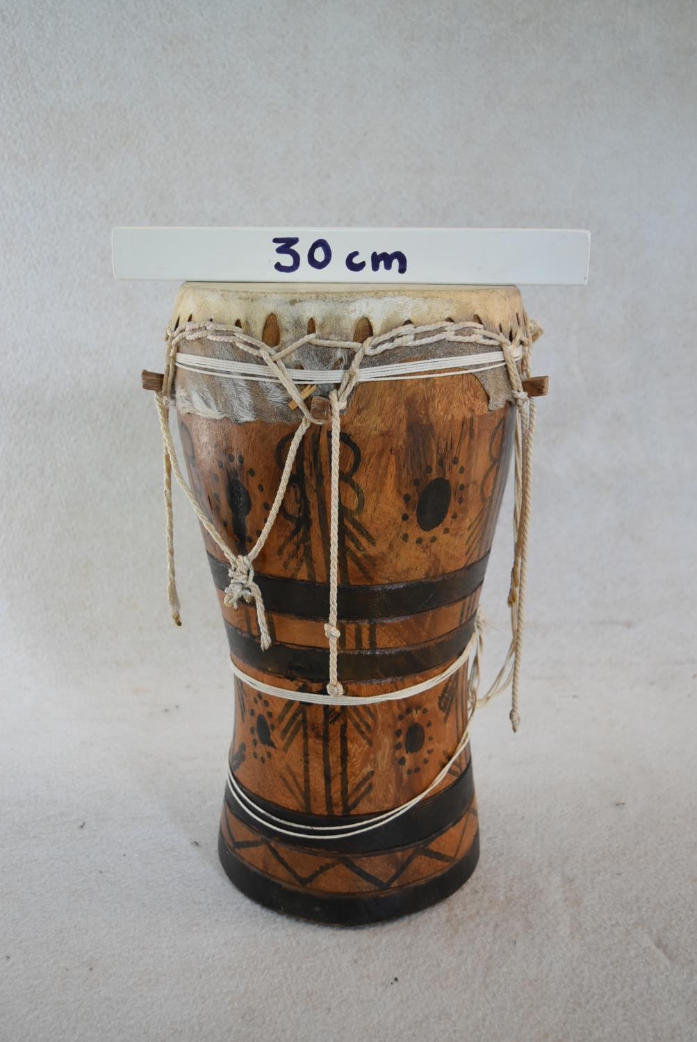 A Senegalese painted hardwood tribal drum. H.44 W.25cm - Image 6 of 6