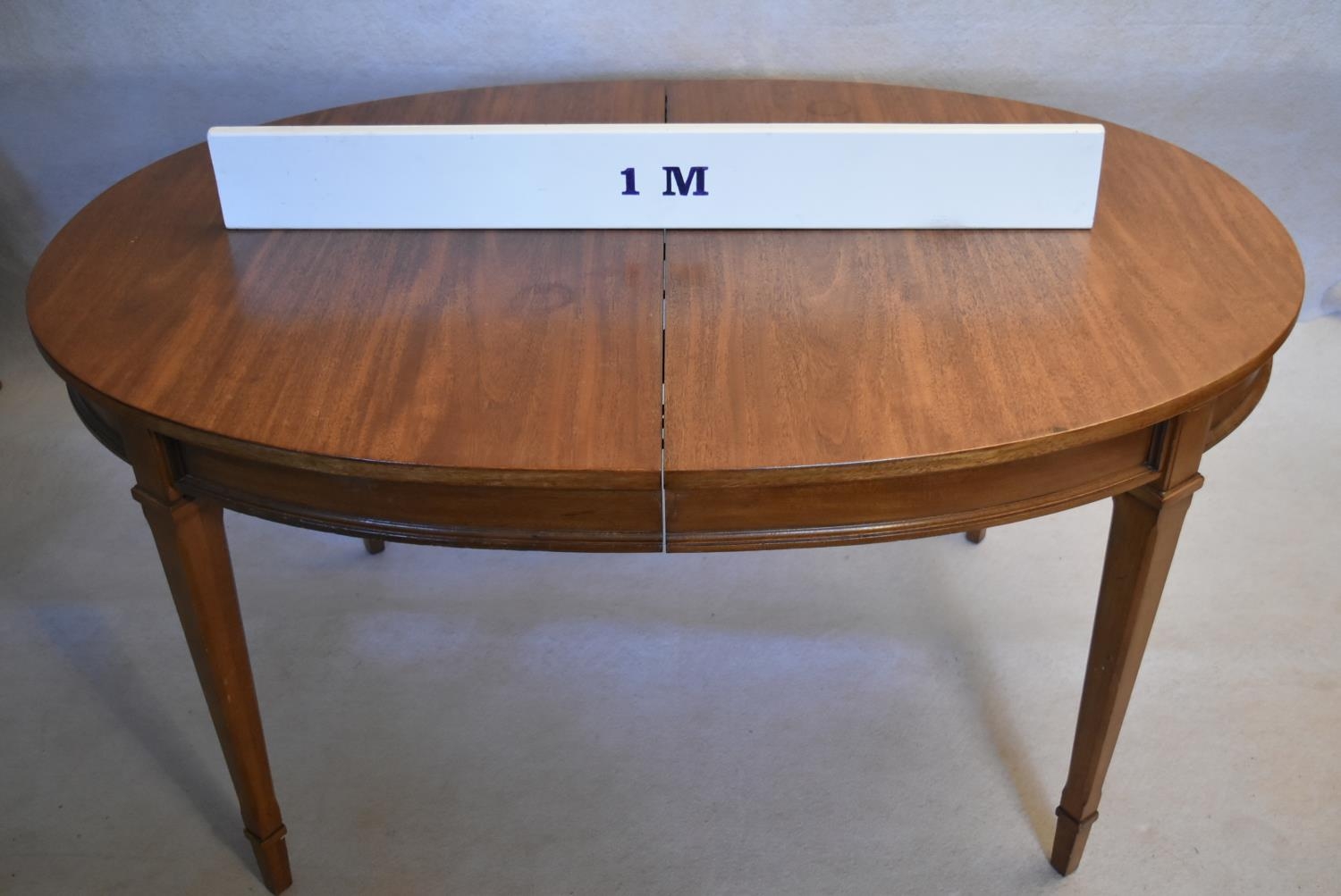 A walnut extending dining table with three extra leaves raised on square tapering supports. H.73 W. - Image 7 of 11