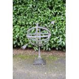 A cast iron armillary sphere on square base. H.35cm