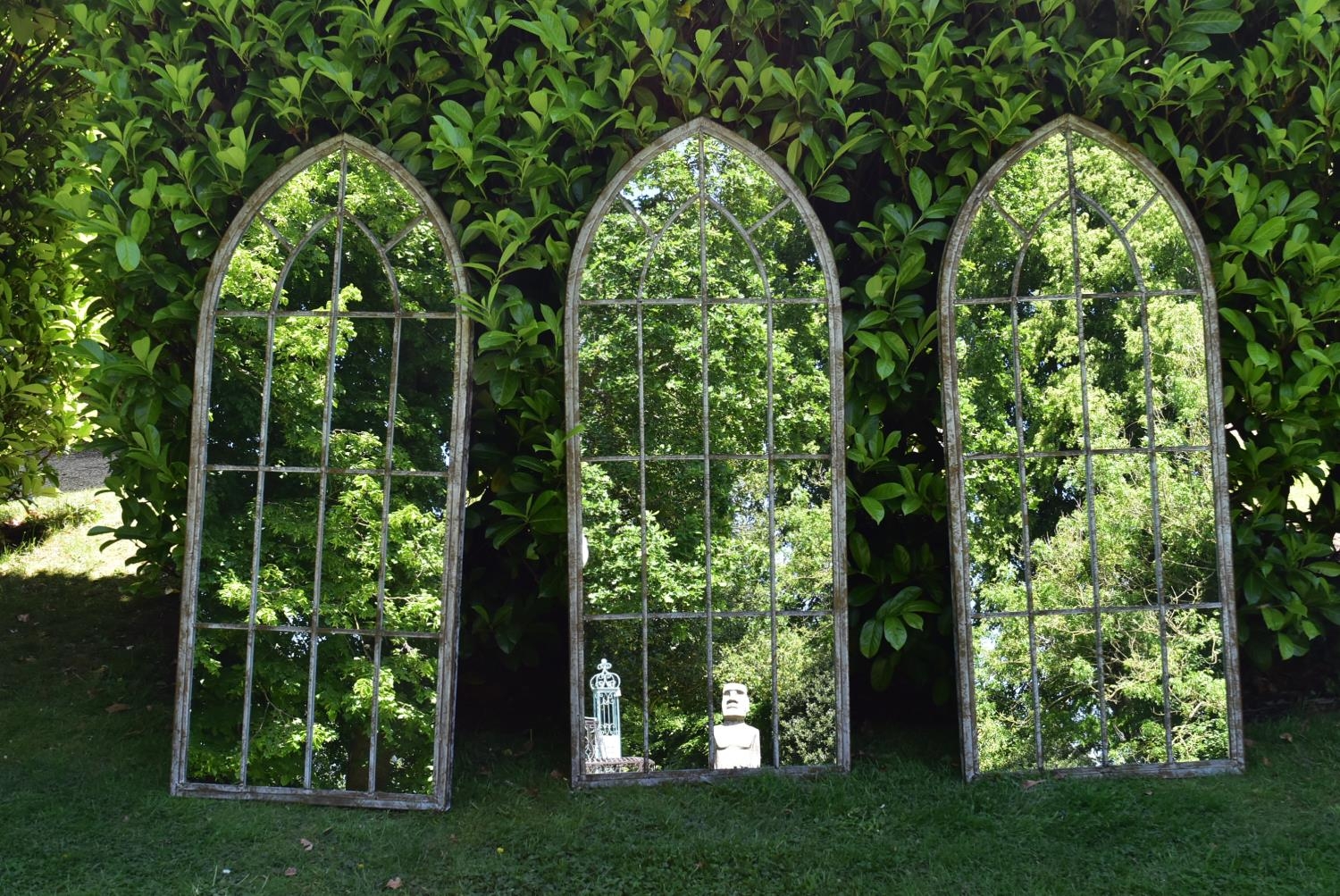 A set of three Gothic arched garden mirrors in distressed painted window pane metal frames. H.159