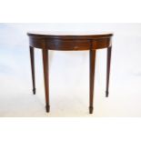 A Georgian mahogany and satinwood crossbanded demi lune tea table with fold over top on double