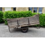 A vintage pine and metal framed garden trolley with drop side. H.85 W.203 D.84cm