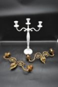 A pair of 19th century brass twin branch piano sconces along with a painted three branch table