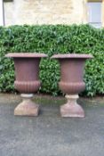 A pair of cast iron campana form garden urns. H.65cm Dia.44cm (2)