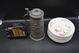 An embossed lidded pewter tankard, a set of eight floral plates and a Victorian marble side piece.