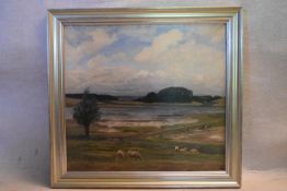 A mid century oil on canvas, English school landscape with grazing sheep in the foreground,