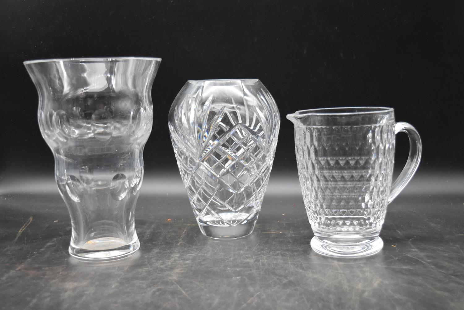 A Villeroy and Boch water jug along with two cut crystal vases. H.25 W.17cm