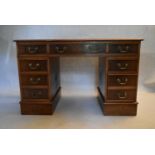 A Georgian style burr walnut three part Georgian style pedestal desk with tooled gilt inset