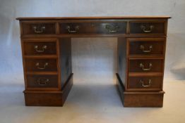 A Georgian style burr walnut three part Georgian style pedestal desk with tooled gilt inset