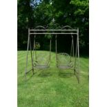 A Victorian style metal framed garden swing with twin scrolling tub armchair seats. H.223 W.180cm
