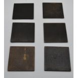 A set of six small bronze place mats impressed with Chinese character marks. H.15 W.15cm