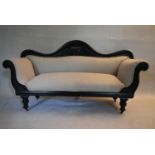 A Victorian ebonised scroll end sofa reupholstered in piped calico on turned tapering supports. H.