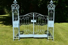 A pair of painted metal 19th century style garden gates with their posts and all over wrought