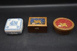 A Wedgwood blue and white lidded dressing table box along with two painted lidded boxes. H.6 W.11cm