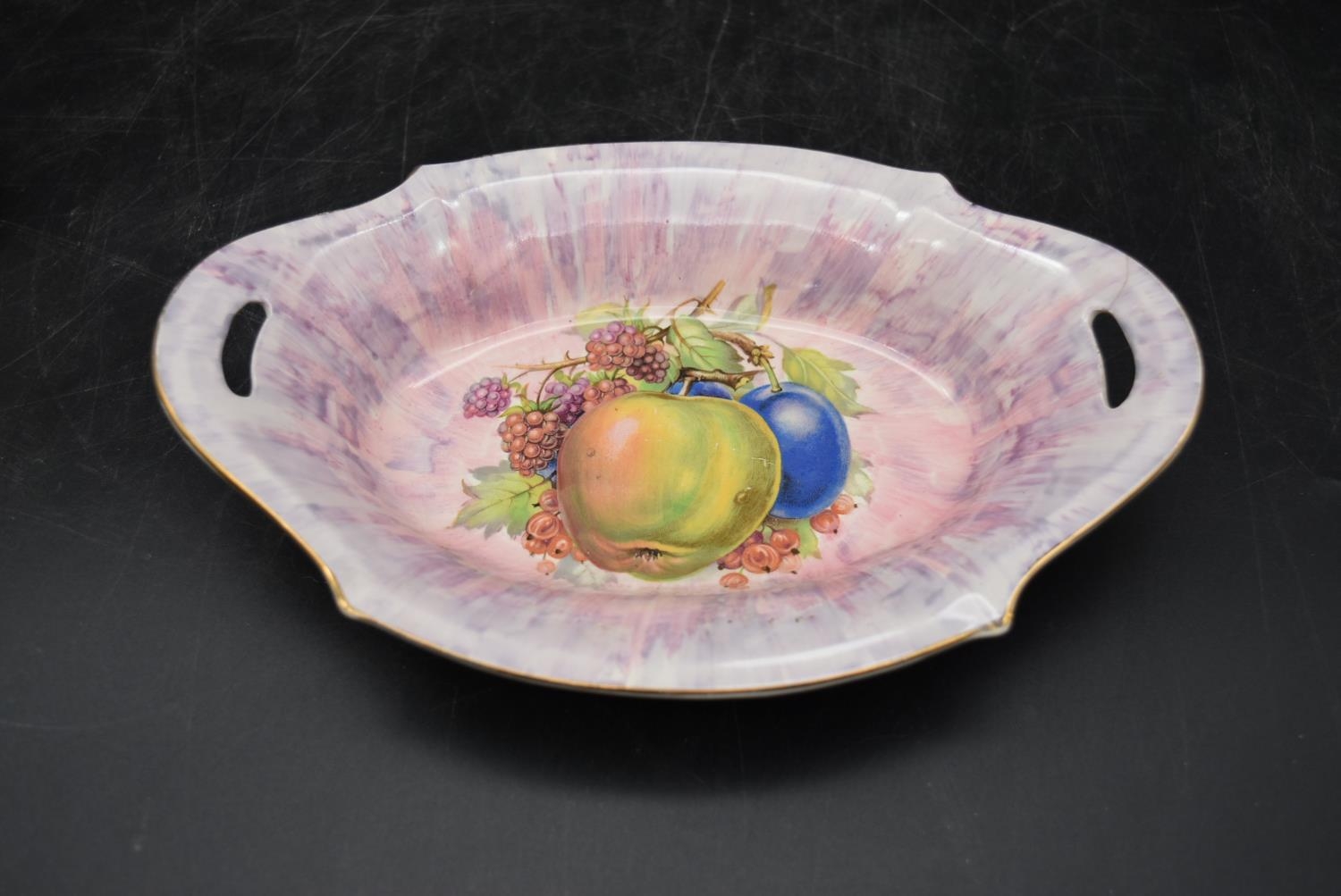 A hand painted Royal Staffordshire dish by Clarice Cliff, along with a porcelain saucer, depicting a - Image 2 of 8