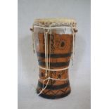 A Senegalese painted hardwood tribal drum. H.44 W.25cm