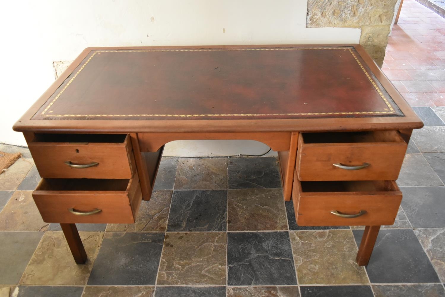 A vintage teak desk with inset gilt tooled leather top on square legs. H.74 W.135 D.75cm - Image 7 of 7