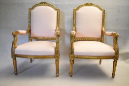 A pair of 19th century French Louis XVI style carved giltwood fauteuils in silk upholstery. Height
