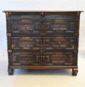 A 17th century oak chest with geometric lozenge moulded drawers raised on shaped block supports. H.