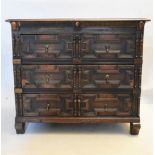 A 17th century oak chest with geometric lozenge moulded drawers raised on shaped block supports. H.